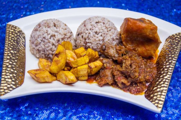 Ofada Rice Fried Plantain Assorted Meats Ayamashe Sauce and Stewed Fish