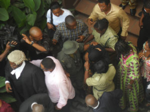 Ibinabo protected by family and friends as she leaves the courtroom. Photo: Odunayo Abiodun