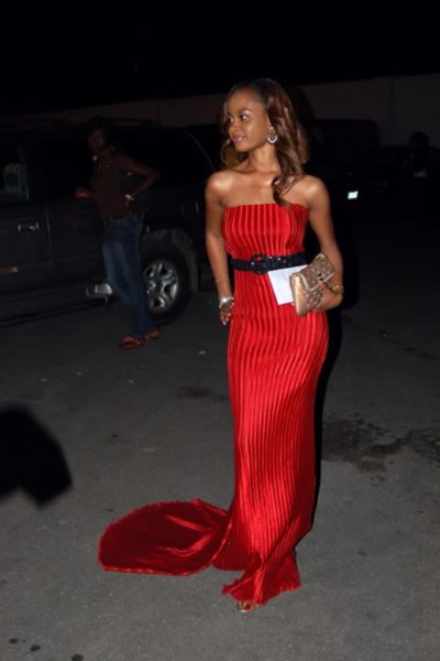 Omowunmi in a Red train gown at a fashion Show