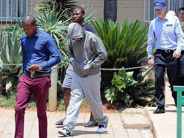 Oscar Pistorius leaves the Boschkop police station, east of Pretoria, South Africa, on Feb. 14, 2013, en route to appear in court