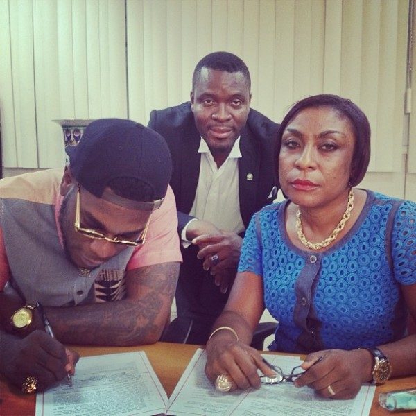 Burna-Boy-his-mother-sign-Glo-deal-600x600