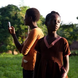 Two women in Nigeria using a mobile phone