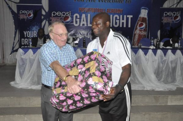 Consultant to Pepsi Football Academy, Mr. Iain Nelson presenting a gift to Mr. Baba Labaran, Coordinator, PFA Kaduna