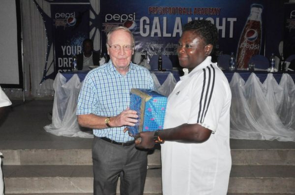 Consultant to Pepsi Football Academy, Mr. Iain Nelson presenting a gift to Mrs. Rachael Enagbare, Coordinator, PFA Benin