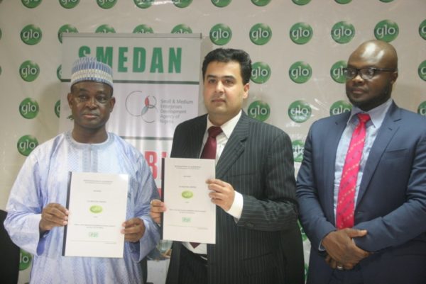 Director General, SMEDAN, Hon Bature Umar Masari (left) and Globacom’s Regional Chief Marketing Officer, Ashok Israni, (Centre) displaying copies of the signed Glo-SMEDAN partnership at a press conference held at Mike Adenuga Towers, Lagos. Right is Globacom’s Head, Corporate Sales, Kamaldeen Shonibare.