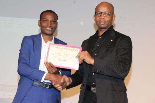 Uzoma Dozie, CEO, Diamond Bank, presenting a certificate  to one of the honorees