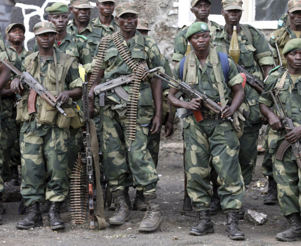 Government army FARDC soldiers stand in a line at an army barrack as they return to Goma