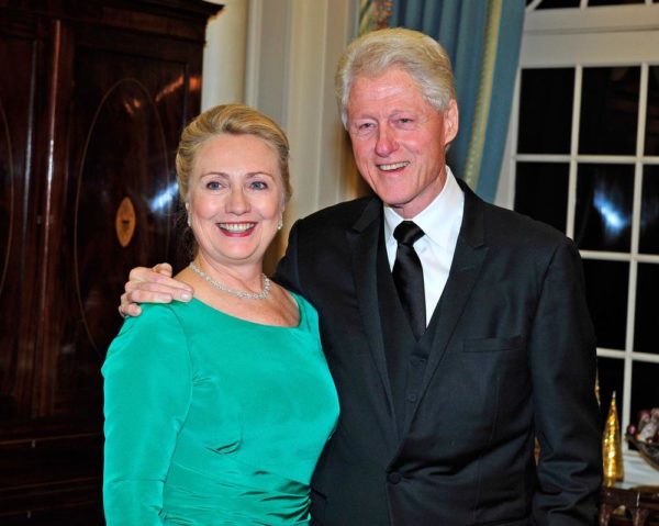 WASHINGTON, DC - DECEMBER 1:  U.S. Secretary of State Hillary Clinton and former U.S. President Bill Clinton (R) look on following a dinner for Kennedy honorees hosted by U.S. Secretary of State Hillary Rodham Clinton at the U.S. Department of State on December 1, 2012 in Washington, DC. The 2012 honorees are Buddy Guy, actor Dustin Hoffman, late-night host David Letterman, dancer Natalia Makarova, and members of the British rock band Led Zeppelin Robert Plant, Jimmy Page, and John Paul Jones. (Photo by Ron Sachs - Pool/Getty Images)