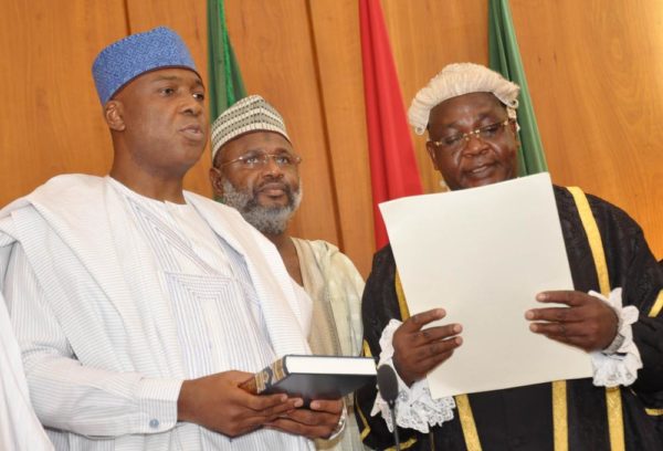 PIC.15.CLERK OF THE NATIONAL ASSEMBLY, SALISU MAIKASUWA (R) SWEARINNG-IN  THE SENATE PRESIDENT, BUKOLA SARAKI AT THE INAUGURATION OF THE 8TH  NATIONAL ASSEMBLY IN ABUJA ON TUESDAY (9/6/15). 3015/9/6/2015/CH/BJO/NAN