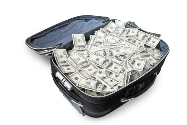 lot of money in a suitcase isolated on white