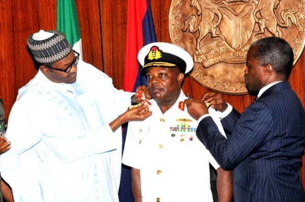PIC 3. PRESIDENT MUHAMMADU BUHARI (L) AIDED BY VICE-PRESIDENT YEMI OSINBAJO IN DECORATING THE CHIEF OF NAVAL STAFF, IBOK ETE EKWE IBAS WITH HIS NEW RANK OF VICE-ADMIRAL, AT THE PRESIDENTIAL VILLA IN ABUJA ON THURSDAY (13/8/15). 5928/13/8/2015/ICE/CH/NAN