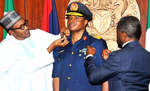 PIC 4. PRESIDENT MUHAMMADU BUHARI (L) AIDED BY VICE-PRESIDENT YEMI OSINBAJO IN DECORATING THE CHIEF OF AIR STAFF, AIR VICE-MARSHAL SADIQUE ABUBARKAR WITH HIS NEW RANK OF AIR-MARSHAL AT THE PRESIDENTIAL VILLA IN ABUJA ON THURSDAY (13/8/15). 5929/13/8/2015/ICE/CH/NAN