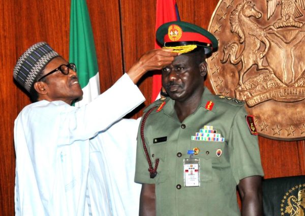 PIC.6. PRESIDENT MUHAMMADU BUHARI DECORATING  THE CHIEF OF ARMY STAFF,  MAJ.-GEN. TUKUR  BURATAI WITH HIS NEW RANK CAP OF  LT.-GEN,  AT THE   PRESIDENTIAL VILLA IN ABUJA ON THURSDAY (13/8/15). 5931/13/8/2015/ICE/CH/NAN