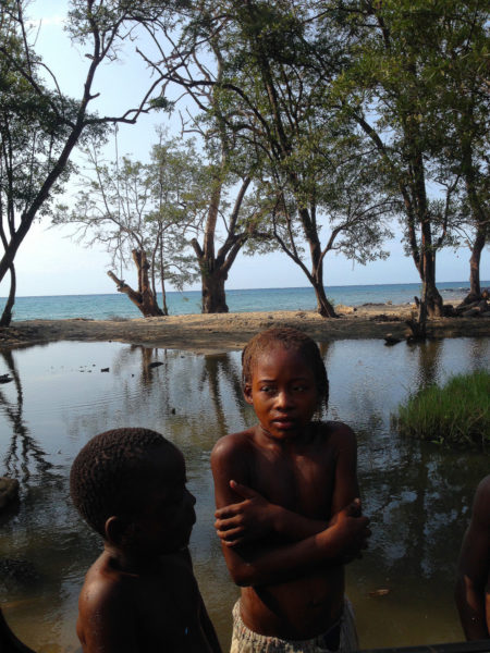 Two children moments after enjoying an afternoon swim in a shallow lake