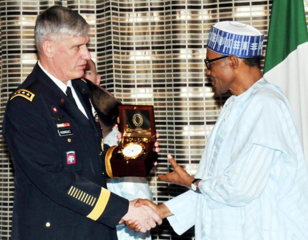 PIC.6.PRESIDENT MUHAMMADU BUHARI (R) RECEIVING A SOUVENIR FROM THE VISITING COMMANDER OF THE U.S. AFRICAN COMMAND, GEN. DAVID RODRIGUEZ, IN ABUJA ON WEDNESDAY (14/10/15). 7140/14/10/2015/ICE/CH/NAN