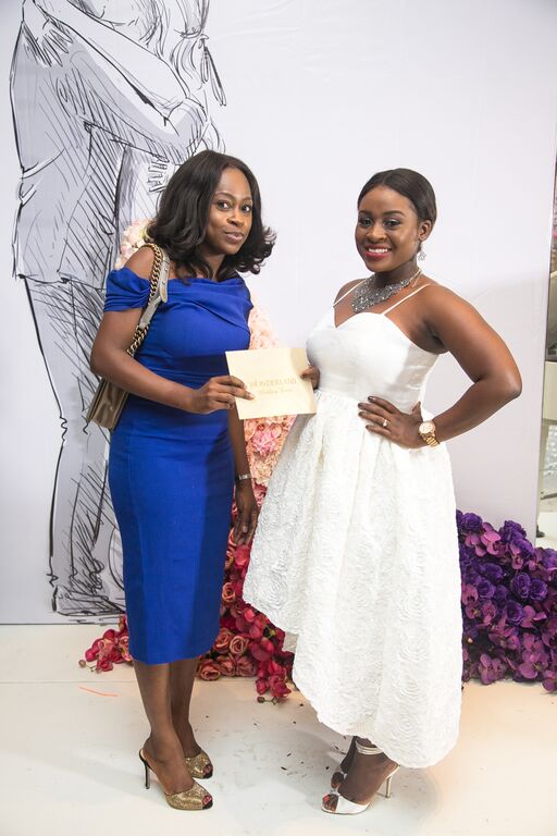 Yeside Laguda of Blush by MyQ presenting the Wedding Dress prize to Blessing