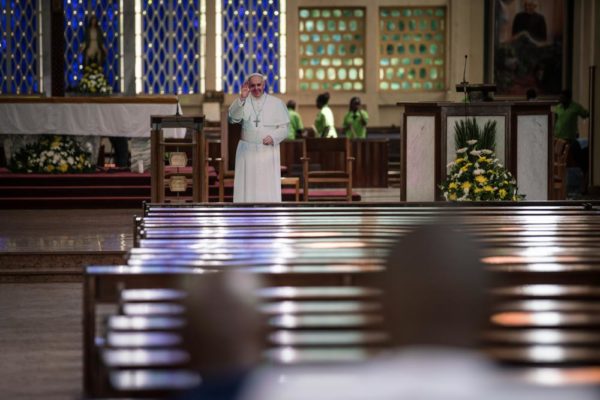 NAIROBI, KENYA - NOVEMBER 24: Worshipers pray at the Holy Family Basilica where an effigy representing Pope Francis has been set up on the altar on November 24, 2015 in Nairobi, Kenya. Pope Francis makes his first visit to Kenya on a five day African tour that is scheduled to include Uganda and the Central African Republic. Africa is recognised as being crucial to the future of the Catholic Church with the continentís Catholic numbers growing faster than anywhere else in the world. (Photo by Nichole Sobecki/Getty Images)