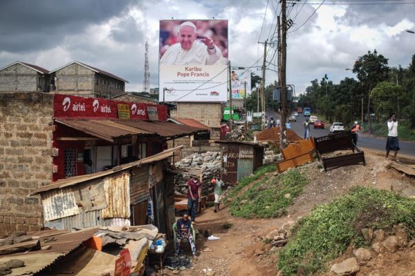 NAIROBI, KENYA - NOVEMBER 24: A poster welcoming Pope Francis to Kenya is pictured in the Kangemi slum on November 24, 2015 in Nairobi, Kenya. Pope Francis makes his first visit to Kenya on a five day African tour that is scheduled to include Uganda and the Central African Republic. Africa is recognised as being crucial to the future of the Catholic Church with the continent's Catholic numbers growing faster than anywhere else in the world. (Photo by Nichole Sobecki/Getty Images)