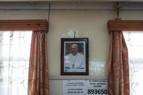 NAIROBI, KENYA - NOVEMBER 24: A portrait of Pope Francis hangs in the St. Joseph the Worker Parish in Nairobi's Kangemi slum on November 24, 2015 in Kenya. Pope Francis makes his first visit to Kenya on a five day African tour that is scheduled to include Uganda and the Central African Republic. Africa is recognised as being crucial to the future of the Catholic Church with the continent's Catholic numbers growing faster than anywhere else in the world. (Photo by Nichole Sobecki/Getty Images)