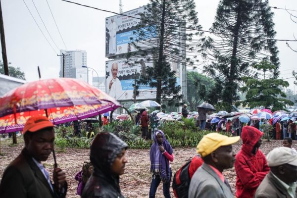 NAIROBI, KENYA - NOVEMBER 26: Crowds gather at the University of Nairobi grounds despite the rain on November 26, 2015, to attend a mass delivered by Pope Francis in Nairobi, Kenya. Pope Francis makes his first visit to Kenya on a five day African tour that is scheduled to include Uganda and the Central African Republic. Africa is recognised as being crucial to the future of the Catholic Church with the continent's Catholic numbers growing faster than anywhere else in the world. (Photo by Nichole Sobecki/Getty Images)