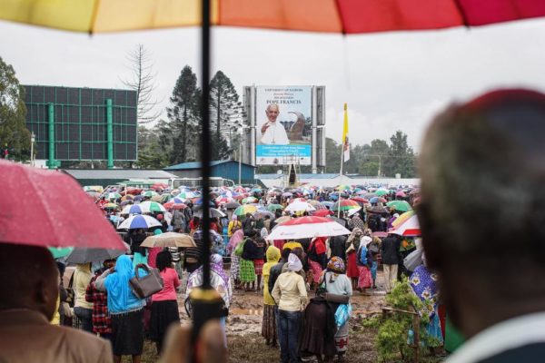 NAIROBI, KENYA - NOVEMBER 26: Crowds gather at the University of Nairobi grounds despite the rain on November 26, 2015, to attend a mass delivered by Pope Francis in Nairobi, Kenya. Pope Francis makes his first visit to Kenya on a five day African tour that is scheduled to include Uganda and the Central African Republic. Africa is recognised as being crucial to the future of the Catholic Church with the continent's Catholic numbers growing faster than anywhere else in the world. (Photo by Nichole Sobecki/Getty Images)