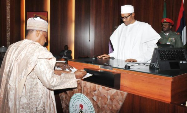 PIC.5. RETIRED BRIG.-GEN MANSUR MOHAMMED DAN-ALI (ZAMFARA), SIGNING THE REGISTER, AFTER TAKING OATH OF OFFICE AS THE MINISTER OF DEFENCE BEFORE PRESIDENT MUHAMMADU BUHARI, AT THE PRESIDENTIAL VILLA IN ABUJA ON WEDNESDAY (11/11/15). 7112/11/11/2015/ICE/NAN