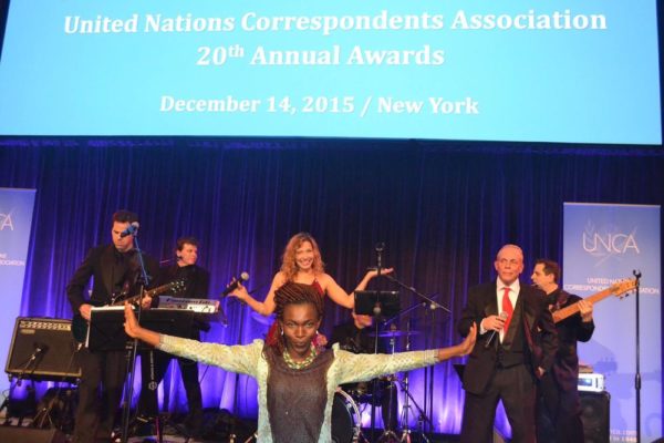 Excited Tina Armstrong with band at the UNCA Awards in New York
