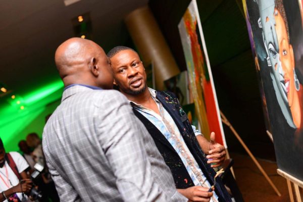 17. Ice Nweke speaking to a guest during the art exhibition