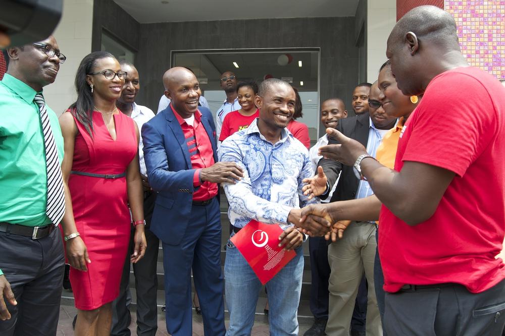 3rd Prize Winner, Chidi Dike, of an All-Expense Paid trip to Genesis Sojouner Hotel Lagos being congratulated