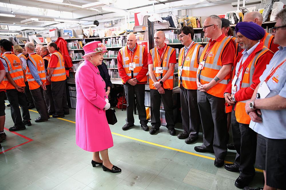WINDSOR, ENGLAND - APRIL 20: Queen Elizabeth II meets postmen as she visits the Queen Elizabeth II delivery office in Windsor with Prince Philip, Duke of Edinburgh on April 20, 2016 in Windsor, England. The visit marks the 500th Anniversary of the Royal Mail delivery service. The Queen and Duke of Edinburgh are carrying out engagements in Windsor ahead of the Queen's 90th Birthday tommorow. (Photo by Chris Jackson - WPA Pool/Getty Images)