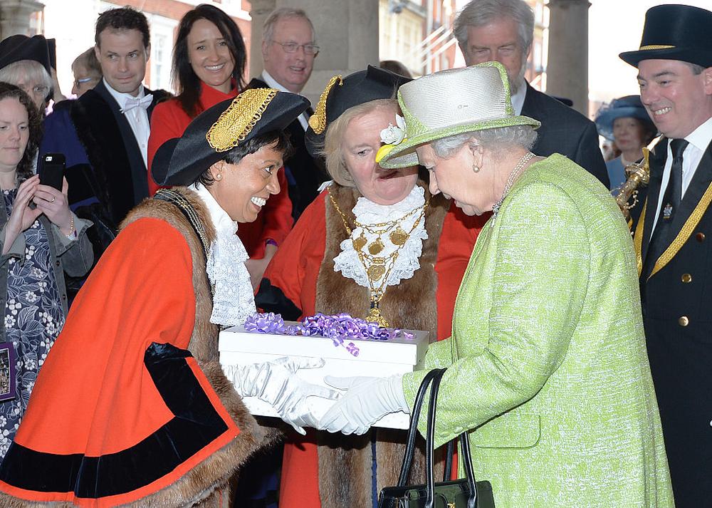 WINDSOR, ENGLAND - APRIL 21: Queen Elizabeth II receives a gift during her 90th Birthday Walkabout on April 21, 2016 in Windsor, England. Today is Queen Elizabeth II's 90th Birthday. The Queen and Duke of Edinburgh will be carrying out engagements in Windsor. (Photo by John Stillwell - WPA Pool/Getty Images)