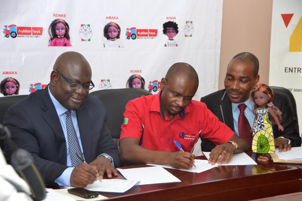 Olawumi Gasper, executive secretary, Lagos State Technical and Vocational Education Board (LASTVEB); Paul Orajiaka, CEO, Auldon Toys, and Awoyera Oluremi, director, modern apprenticeship training program, LASTVEB, at the signing of MoU between LASTVEB and Auldon Toys for the clothing of the Unity Dolls in Lagos.