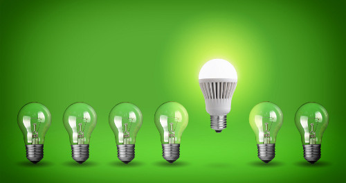 Row of light bulbs.Idea concept on green background.