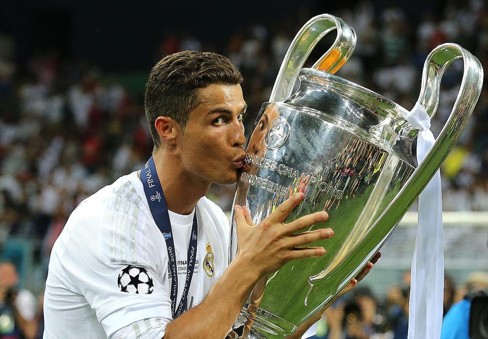 MILAN, ITALY - MAY 28: Cristiano Ronaldo of Real Madrid kisses the trophy following his team's victory in a penalty shootout during the UEFA Champions League final match between Real Madrid and Club Atletico de Madrid at Stadio Giuseppe Meazza on May 28, 2016 in Milan, Italy. (Photo by Matthew Ashton - AMA/Getty Images)