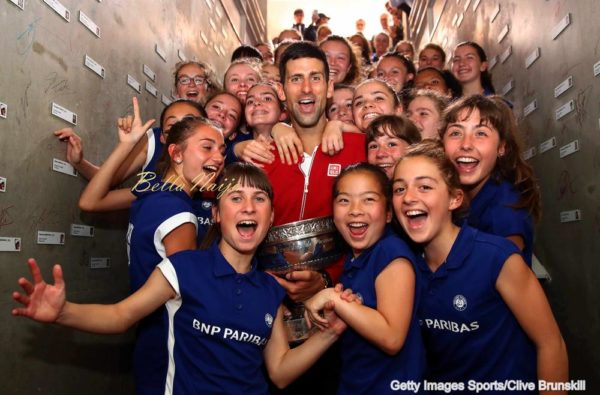 PARIS, FRANCE - JUNE 05: Champion Novak Djokovic of Serbia celebrates with the ball girls following his victory during the Men's Singles final match against Andy Murray of Great Britain on day fifteen of the 2016 French Open at Roland Garros on June 5, 2016 in Paris, France. (Photo by Clive Brunskill for Adidas/Getty Images