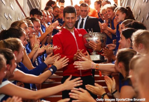 PARIS, FRANCE - JUNE 05: Champion Novak Djokovic of Serbia celebrates with the ball girls following his victory during the Men's Singles final match against Andy Murray of Great Britain on day fifteen of the 2016 French Open at Roland Garros on June 5, 2016 in Paris, France. (Photo by Clive Brunskill for Adidas/Getty Images