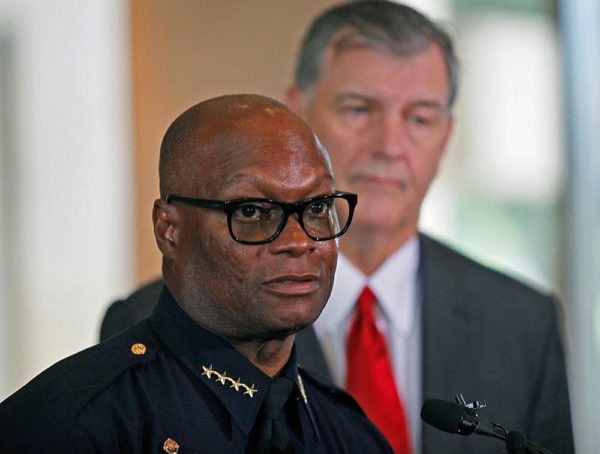 DALLAS, TX - JULY:  Dallas Mayor Mike Rawlings (R) looks on during a press conference at Dallas City Hall as Dallas Police Chief David Brown speaks on the fatal shootings of five police officers on July 8, 2016 in Dallas, Texas. At least one sniper killed five officers and wounded seven others in a coordinated ambush at a anti-police brutality demonstration in Dallas. The sniper was killed, and three other people are in custody, officials said.  (Photo by Stewart  F. House/Getty Images)