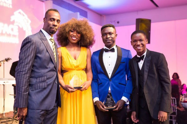 Surprise guest, "Beasts of No Nation" actor Abraham Attah (R) presents the YACE award to the 2016 Fellows