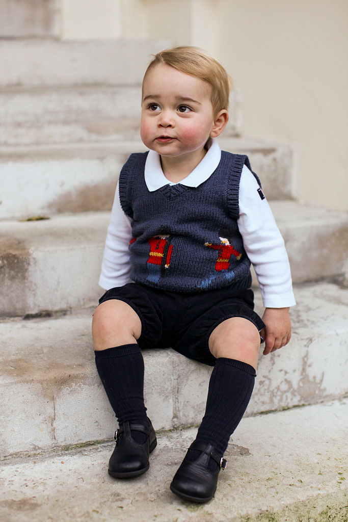 LONDON, ENGLAND - DECEMBER 13 2014: Prince George sits for his official Christmas picture in a courtyard at Kensington Palace in late November of 2014 in London, England. (Photo by The Duke and Duchess of Cambridge/PA Wire via Getty Images)
