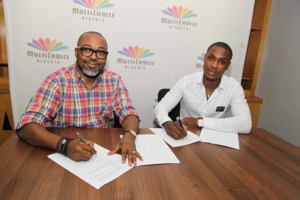 John Ugbe, Managing Director, MultiChoice Nigeria and Super Eagles and Watford football club striker, Odion Jude Ighalo signing the endorsement deal as brand ambassador for MultiChoice Nigeria held at the MultiChoice Headquarters, Tiamiyu Savage, Victoria Island, Lagos on Wednesday, 14th of July, 2016