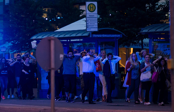MUNICH, GERMANY - JULY 22: Police officers escort people with their hands raised from inside the shopping center as they respond to a shooting at the Olympia Einkaufzentrum (OEZ) at July 22, 2016 in Munich, Germany. According to reports, several people have been killed and an unknown number injured in a shooting at a shopping centre in the north-western Moosach district in Munich. Police are hunting the attacker or attackers who are thought to be still at large. (Photo by Joerg Koch/Getty Images)