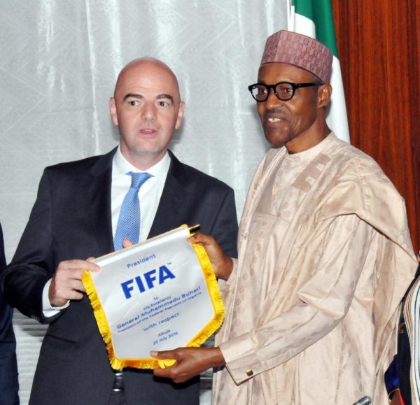 PIC. 20. PRESIDENT MUHAMMADU BUHARI (R), RECEIVING A PENNANT FROM FIFA PRESIDENT, GIANNI INFANTINO, DURING THE LATTERS VISIT TO THE PRESIDENTIAL VILLA IN ABUJA ON MONDAY (25/7/16). 5312/25/7/2016/ICE/EO/BJO/NAN