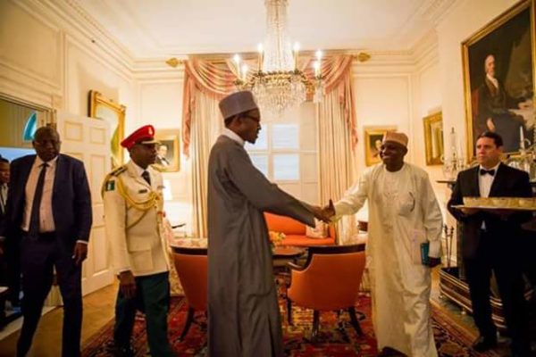 Garba Shehu in handshake with President Buhari