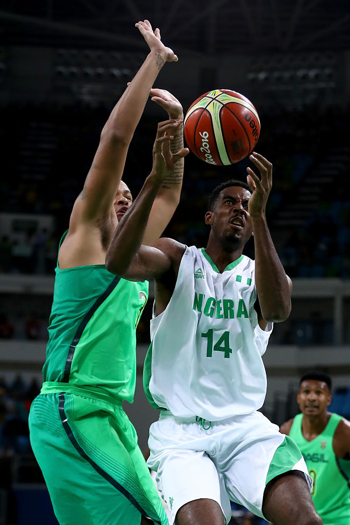 RIO DE JANEIRO, BRAZIL - AUGUST 15: Alade Aminu #14 of Nigeria drives past Rafael Hettsheimeir #30 of Brazil during a Men's Preliminary Pool B match on Day 10 of the Rio 2016 Olympic Games at Carioca Arena 1 on August 15, 2016 in Rio de Janeiro, Brazil. (Photo by Sean M. Haffey/Getty Images)