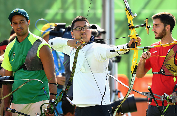 RIO DE JANEIRO, BRAZIL - AUGUST 05: Woojin Kim of Korea (C) competes during the Men's Individual Ranking Round on Day 0 of the Rio 2016 Olympic Games at the Sambodromo Olympic Archery venue on August 5, 2016 in Rio de Janeiro, Brazil. (Photo by Quinn Rooney/Getty Images)