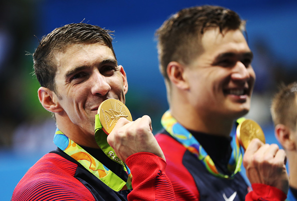 RIO DE JANEIRO, BRAZIL - AUGUST 07: Michael Phelps of United States poses with his Gold medal from the Men's 4 x 100m Freestyle Relay during Day 2 of the Rio 2016 Olympic Games at Olympic Aquatics Stadium on August 7, 2016 in Rio de Janeiro, Brazil. (Photo by Ian MacNicol/Getty Images)
