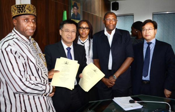 PIC.19. MINISTER OF TRANSPORTATION, CHIBUIKE AMAECHI (L) EXCHANGING A SIGNED AGREEMENT FOR THE COMPLETION OF WARRI-ALADJA- ITAPKE-AJAOKUTA-BARO-ABUJA (CENTRAL) RAILWAY LINE WITH THE VICE PRESIDENT, CHINESE RAILWAY CONSTRUCTION COMPANY (CRCC), CHEN XIAO XING (2ND-L), AT THE AGREEMENT SIGNING CEREMONY IN ABUJA ON FRIDAY (12/8/16). WITH THEM FROM RIGHT ARE: DIRECTOR OF CRCC, DOU YISUO; DIRECTOR OF RAIL TRANSPORT, FEDERAL MINISTRY OF TRANSPORTATION, MOHAMMED BABKOBI AND LEGAL OFFICER OF THE MINISTRY, IJEOMA UCHE.  THE AGREEMENT IS TO COMPLETE AND EXTEND THE CENTRAL RAILWAY LINE TO WARRI TOWN, PORT AND REFINERY; AND TO EXTEND IT NORTHWARD FROM EGANYI-JAKURA-BARO TO ABUJA. 5658/12/8/2016/BJO/NAN