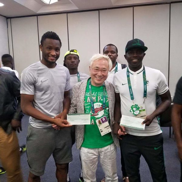 Coach Siasia and Captain Mikel receiving the cheques from Dr. Takasu