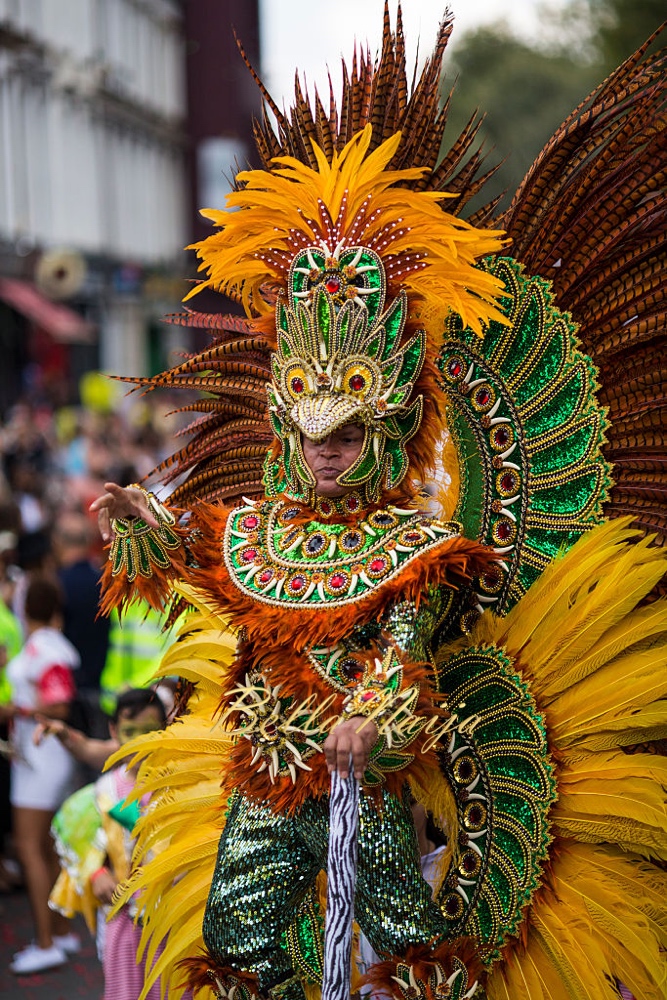 LONDON, ENGLAND - AUGUST 29: A performer takes part in the Notting Hill Carnival on August 29, 2016 in London, England. The Notting Hill Carnival, which has taken place annually since 1964, is expected to attract over a million people. The two-day event, started by members of the Afro-Caribbean community, sees costumed performers take to the streets in a parade and dozens of sound systems set up around the Notting Hill streets. (Photo by Jack Taylor/Getty Images)