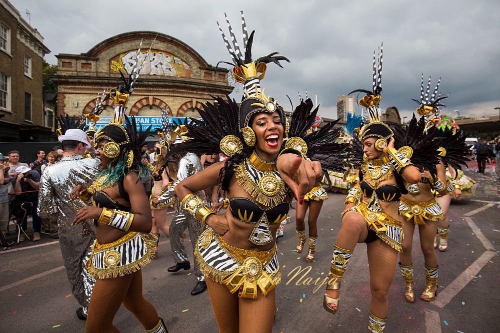 LONDON, ENGLAND - AUGUST 29: Performers take part in the Notting Hill Carnival on August 29, 2016 in London, England. The Notting Hill Carnival, which has taken place annually since 1964, is expected to attract over a million people. The two-day event, started by members of the Afro-Caribbean community, sees costumed performers take to the streets in a parade and dozens of sound systems set up around the Notting Hill streets. (Photo by Jack Taylor/Getty Images)